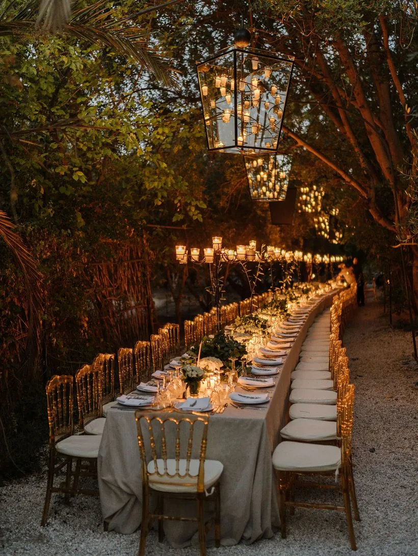 Serpentine candlelit banquet table in a garden